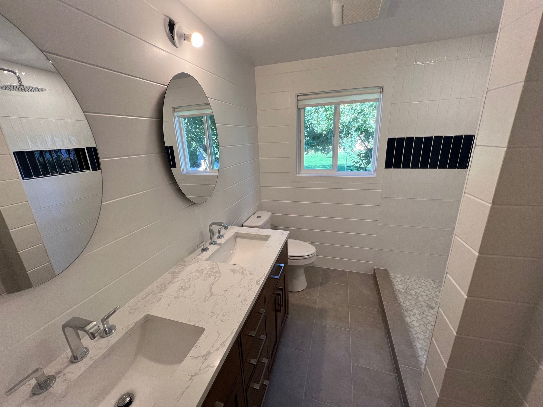Double vanity bathroom with round mirrors