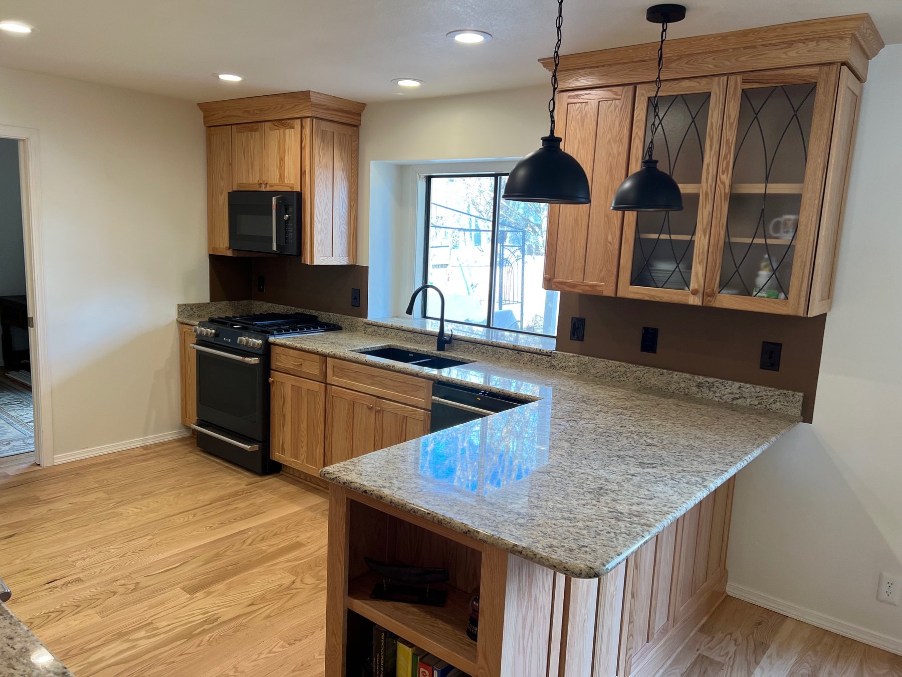 Warm wood kitchen cabinets with granite countertops