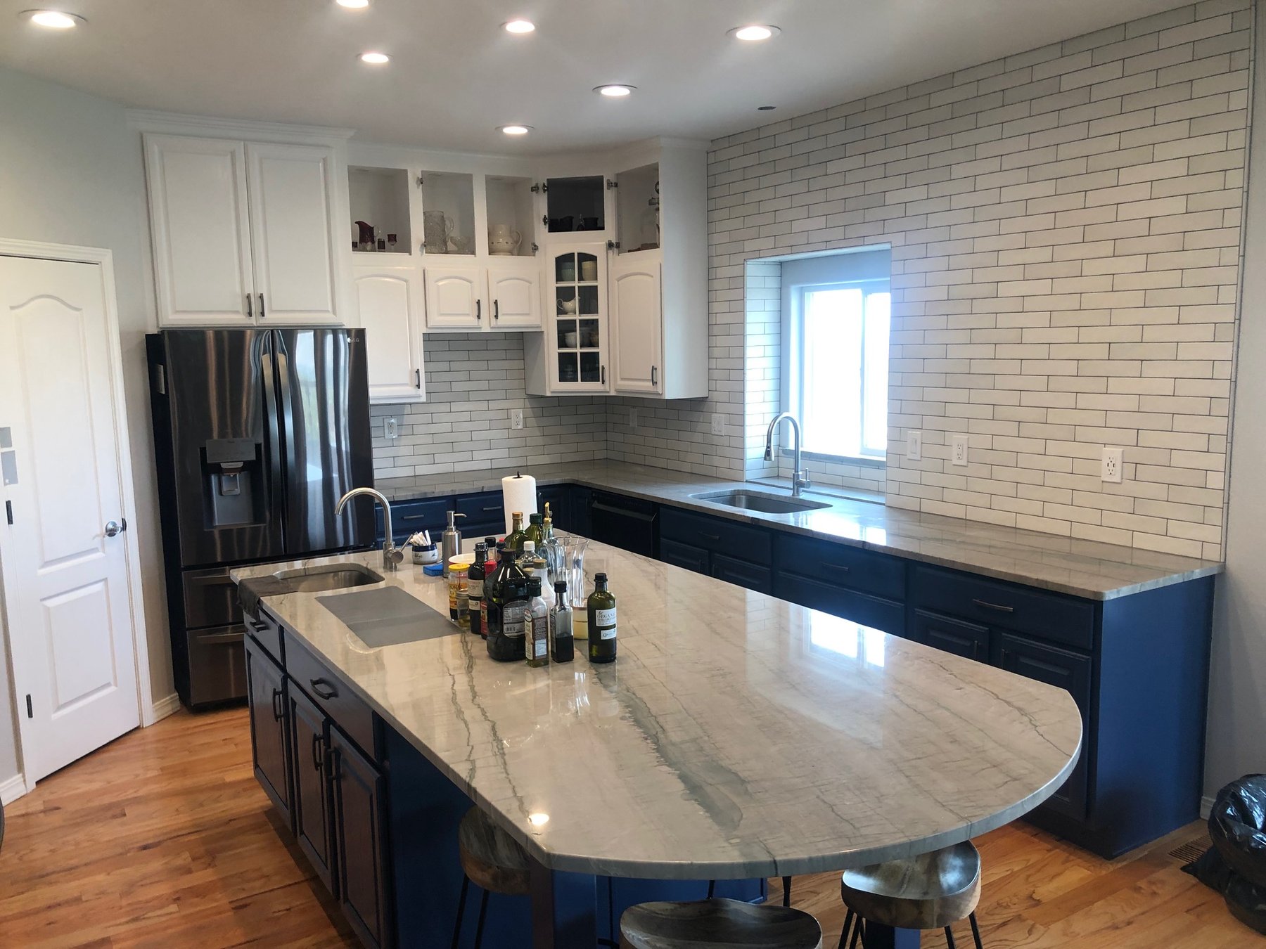 Navy and white kitchen with a large island and bar seating
